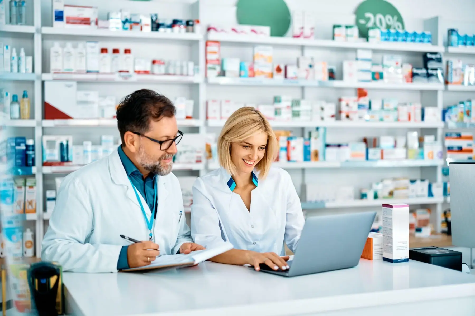 Pharmacists-collaborating-at-a-counter-in-a-pharmacy.webp